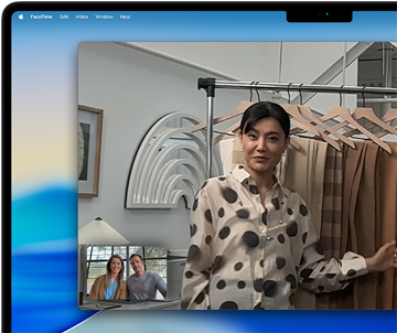 A video call on a MacBook Pro where a woman shows fabrics to two people on the call, with Center Stage keeping her centered in the frame as she moves around